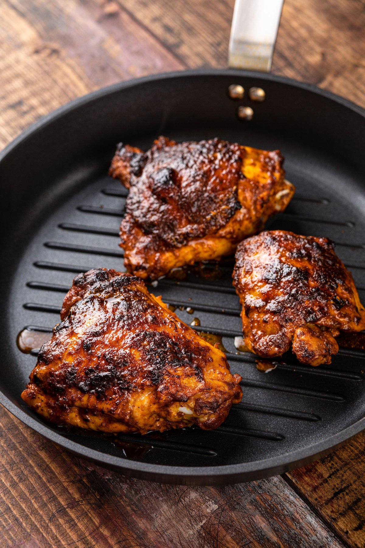 Cooking the pollo asado over a grill.