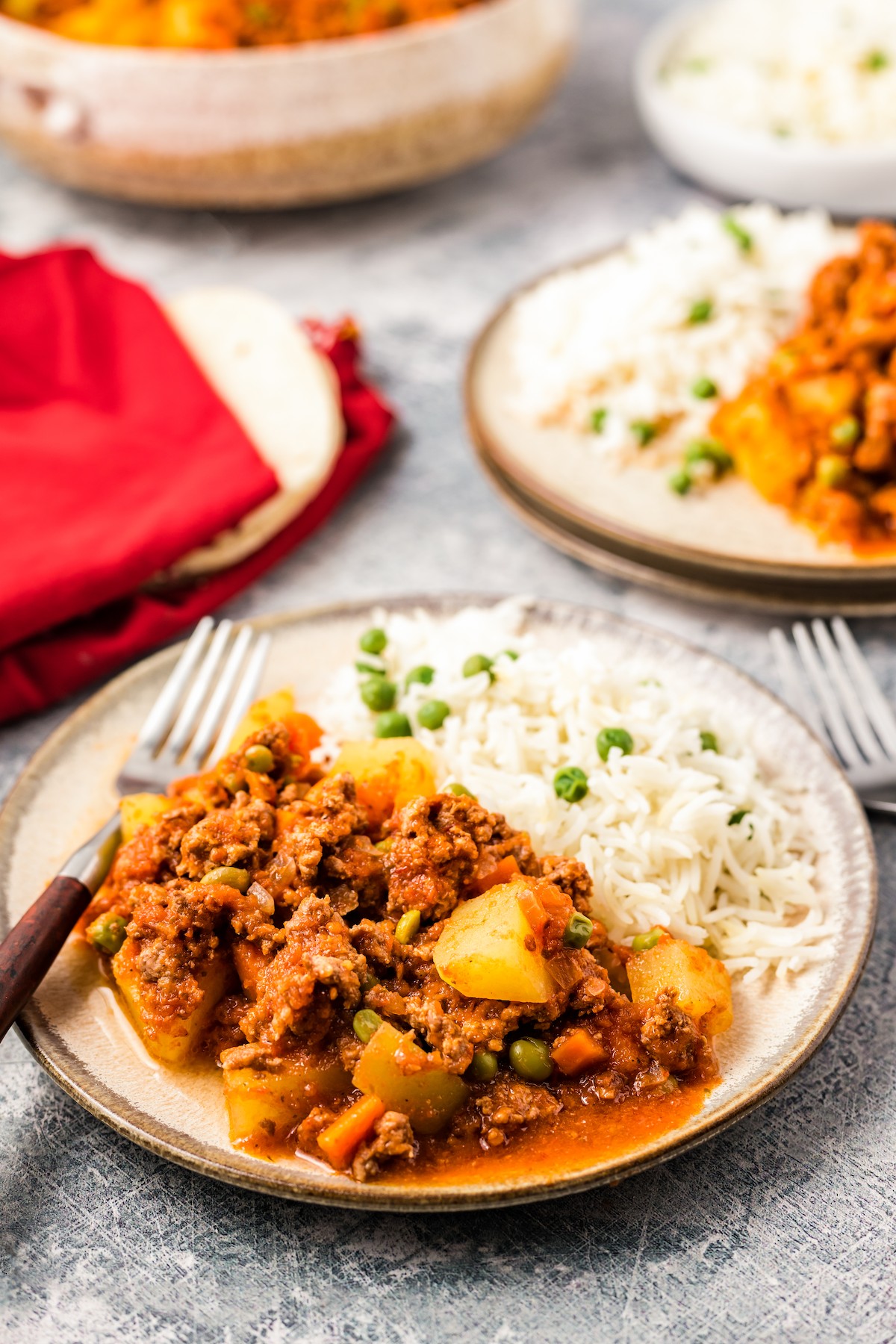 Two plates with picadillo and rice.